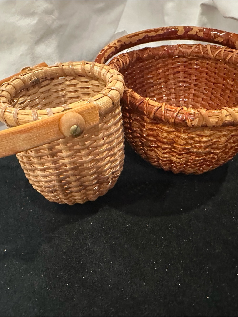 Handcrafted, woven Nantucket-style baskets, featuring wooden swing handles